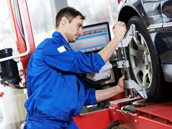 auto mechanic at wheel alignment