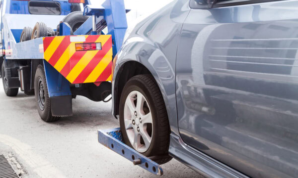 tow truck towing a broken car